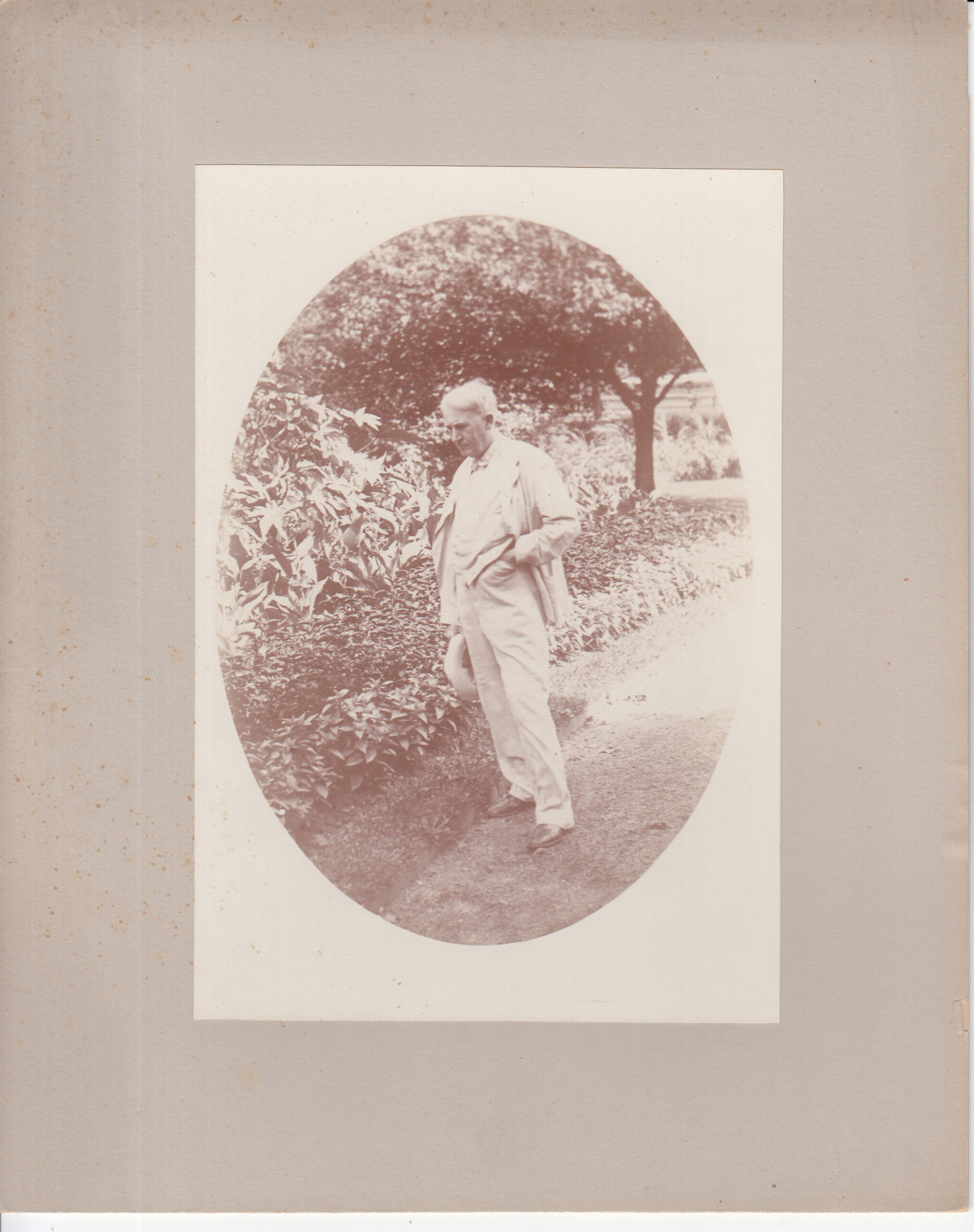Thomas Edison standing among plants in the garden of his Fort Myers home