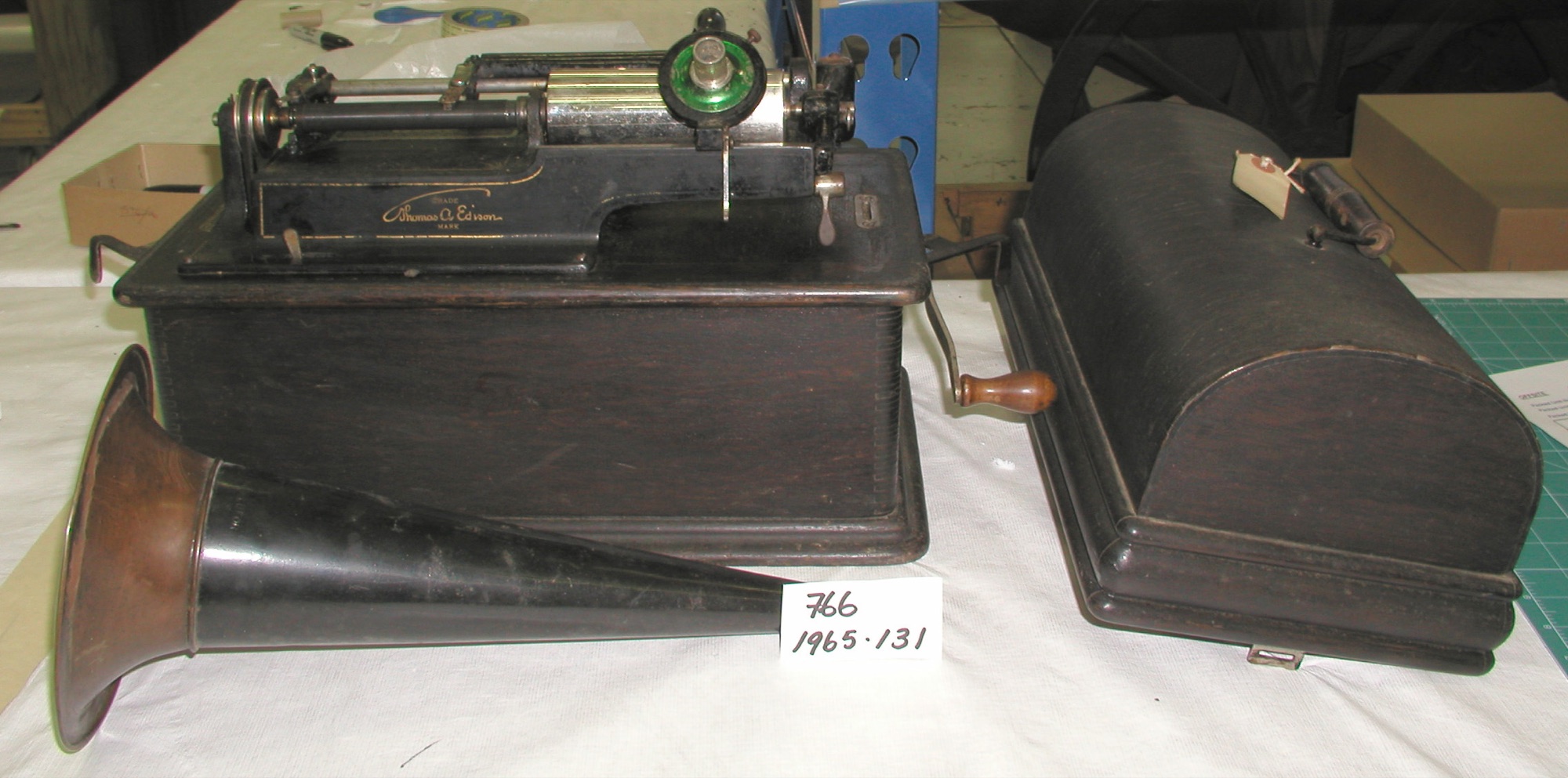 Edison Home Phonograph with its horn and a group of cylinder records