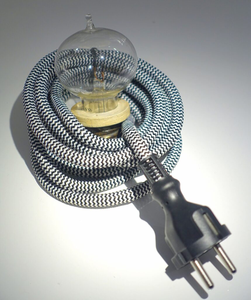 An Edison incandescent electric lamp manufactured in 1881 with carbon filament visible