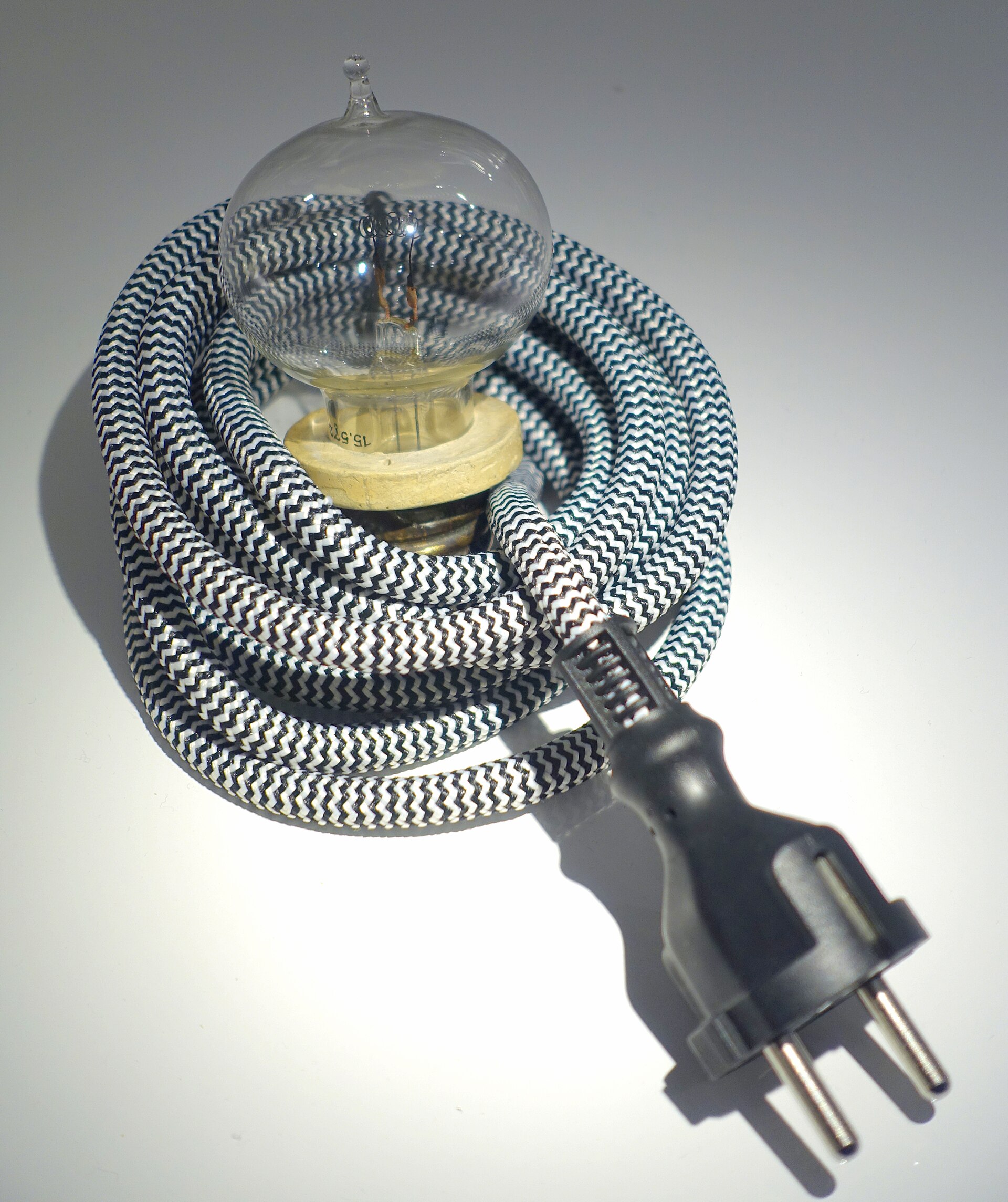 An Edison incandescent lamp made in 1881 with a looped carbon filament