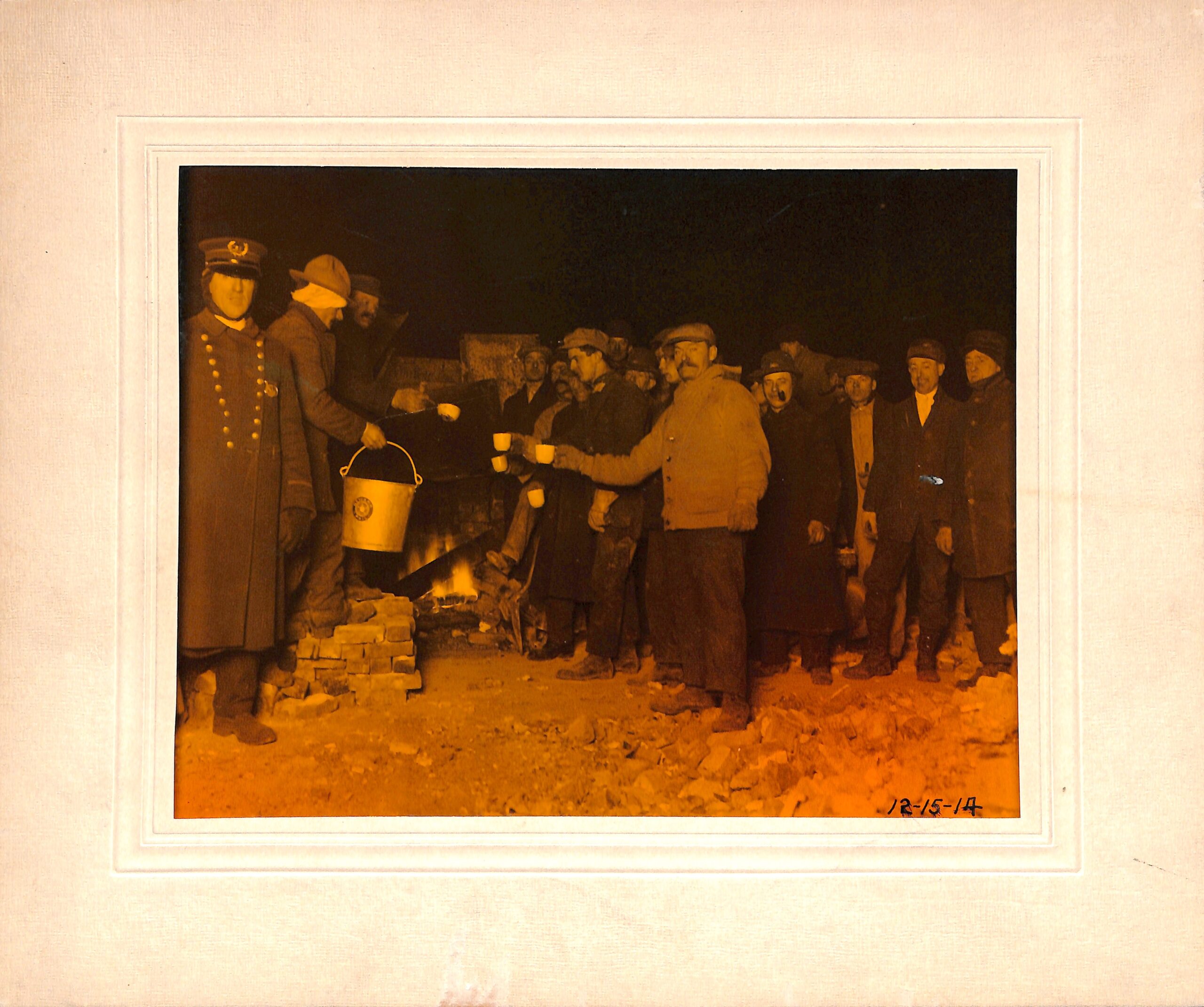 Edison workers taking sandwiches and coffee during night clean-up after the 1914 fire