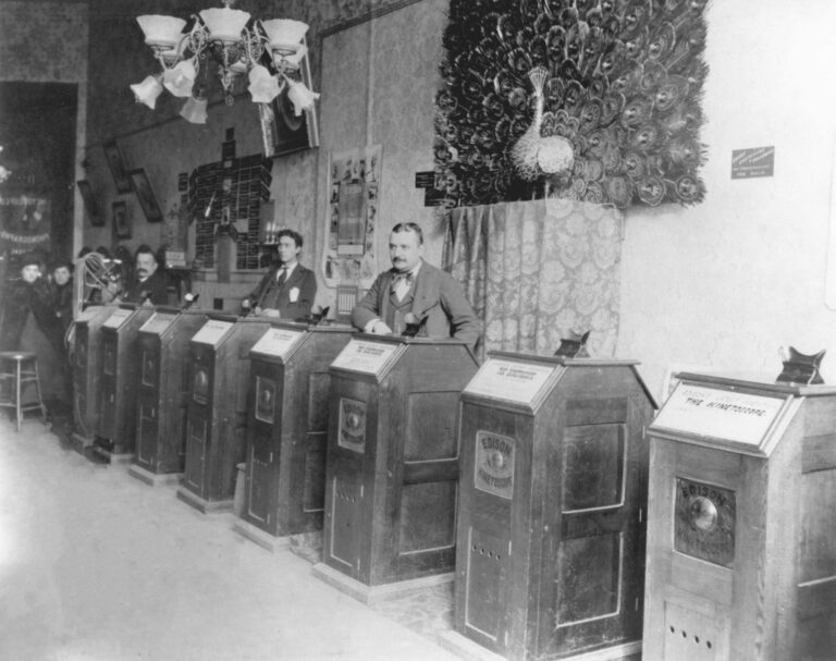 Customers looking into a row of Kinetoscope cabinets in a San Francisco parlour around 1894