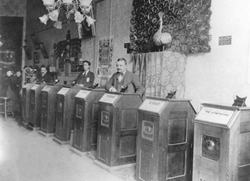 Customers looking into a row of Kinetoscope cabinets in a San Francisco parlour around 1894