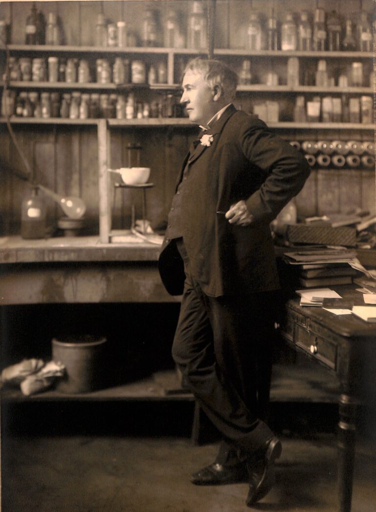 Thomas Edison standing among electrical apparatus in his West Orange laboratory in 1906